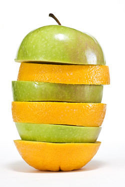 Slices of apple and orange, stacked to create a new fruit