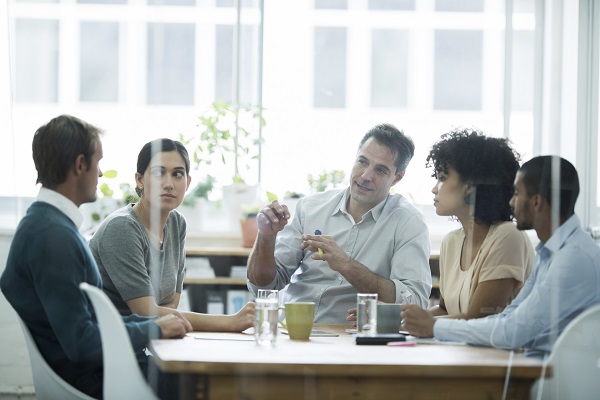 Experienced businessman explaining a concept to his team